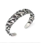 bracelet viking qui est en alliage d'argent. Le bracelet est tressé de torsades métalliques aléatoires pour obtenir un bracelet très racé au design sobre et brut qui figure un chaos organisé. Le bracelet est couleur argentée.